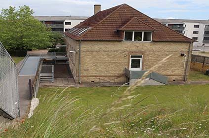 Før-billede af huset fra skråningen